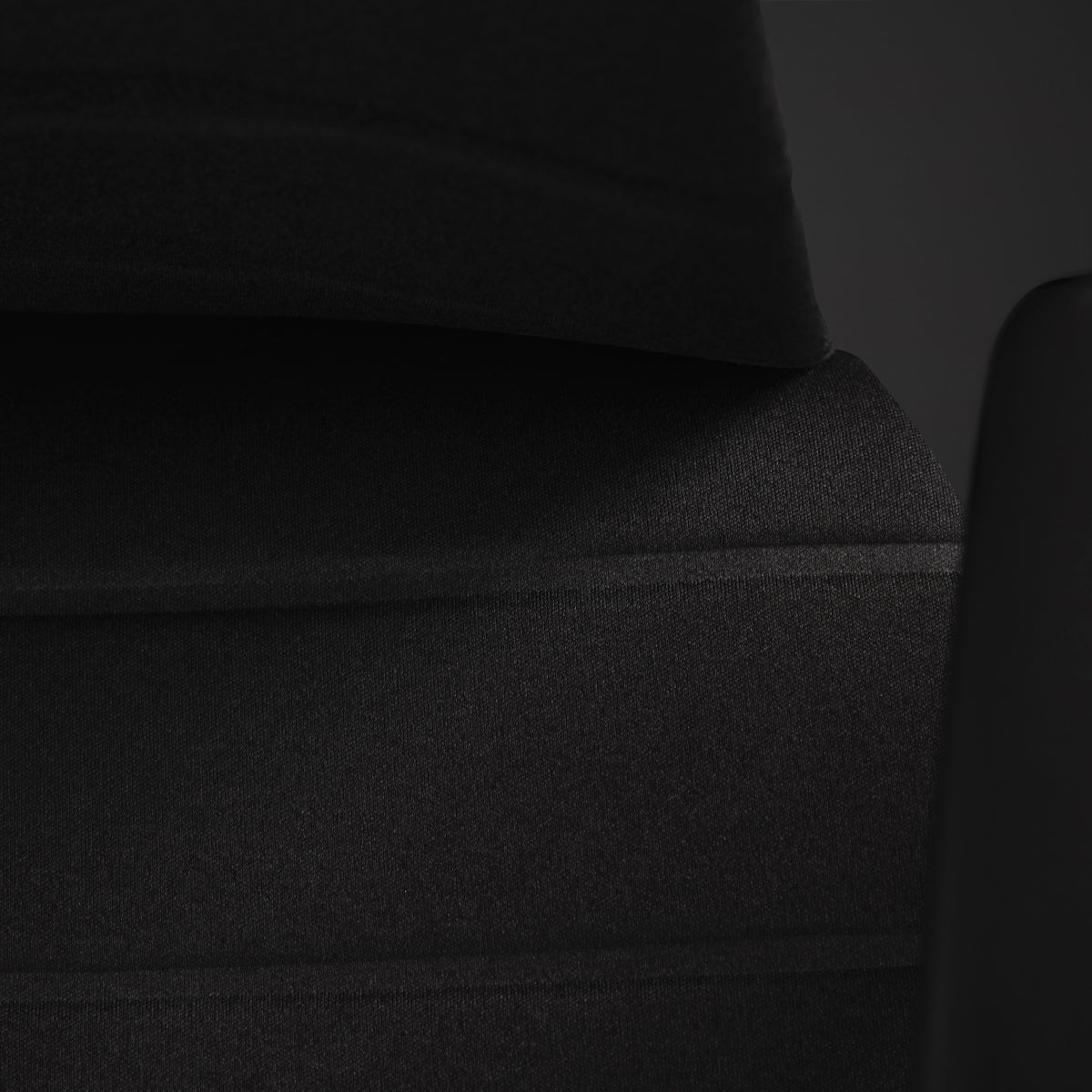 黑色背景中Embody电竞椅椅座上的多层承托技术特写。